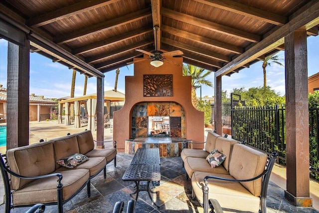 view of patio / terrace with ceiling fan and an outdoor living space