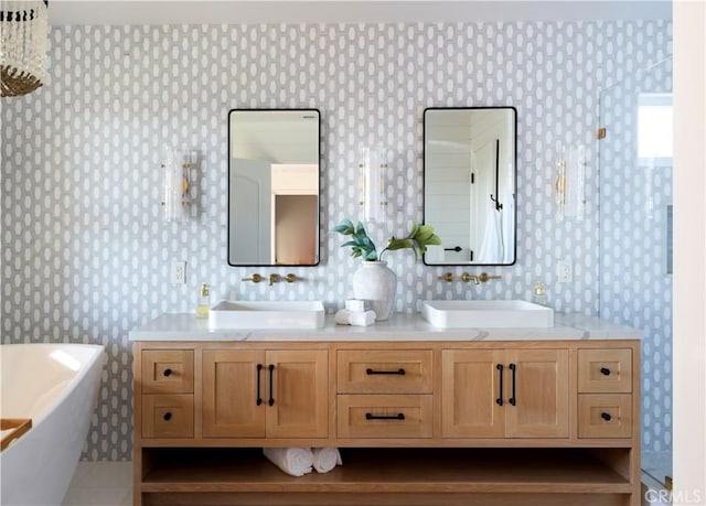 bathroom with vanity and a bath