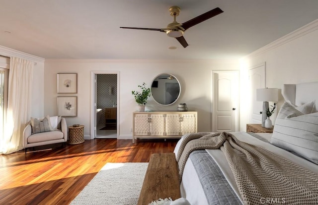 bedroom featuring ceiling fan, connected bathroom, dark wood-type flooring, and ornamental molding