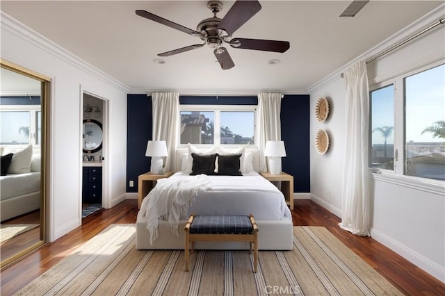 bedroom featuring ceiling fan, crown molding, and hardwood / wood-style floors