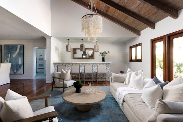 living room featuring an inviting chandelier, wood walls, wooden ceiling, wood-type flooring, and beam ceiling