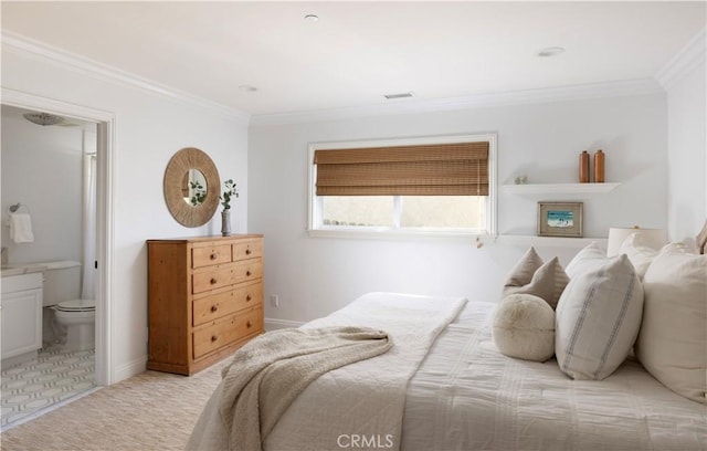 bedroom featuring ensuite bathroom, light colored carpet, and ornamental molding