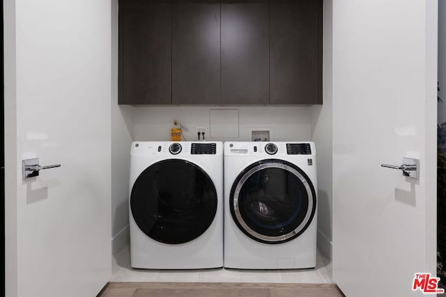 laundry area with cabinets and separate washer and dryer