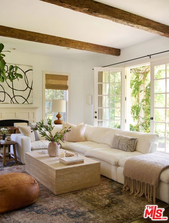 living room featuring beam ceiling