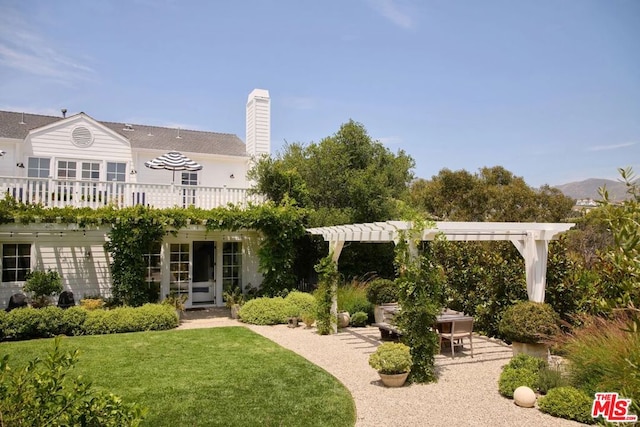 back of house with a patio area, a lawn, a balcony, and a pergola