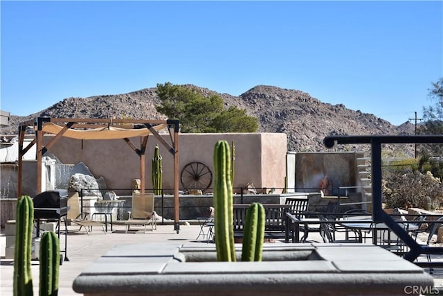 view of patio with a grill and a mountain view