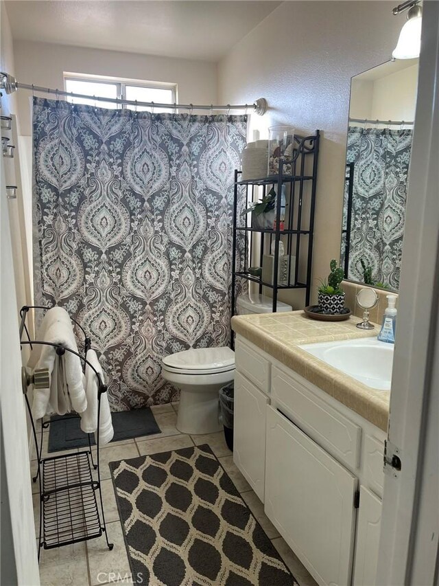 bathroom with tile patterned floors, toilet, and vanity