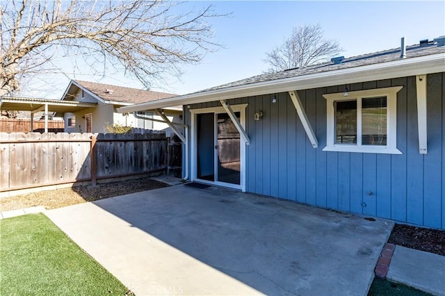 view of exterior entry with a patio area