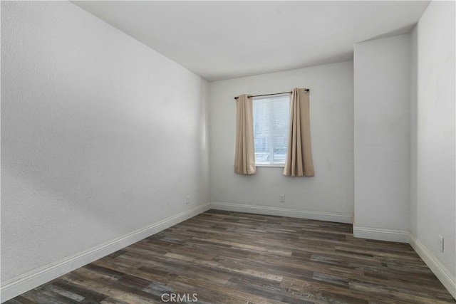 empty room with dark wood-type flooring