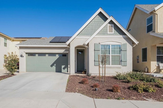 view of front facade with a garage and solar panels