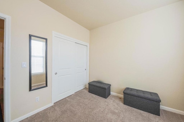 living area featuring light carpet