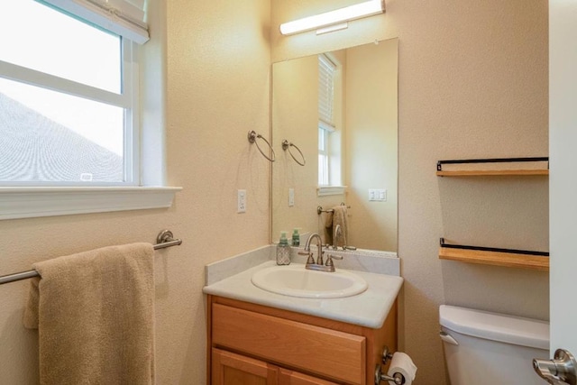 bathroom with vanity and toilet