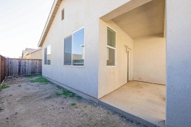 view of side of property with a patio area