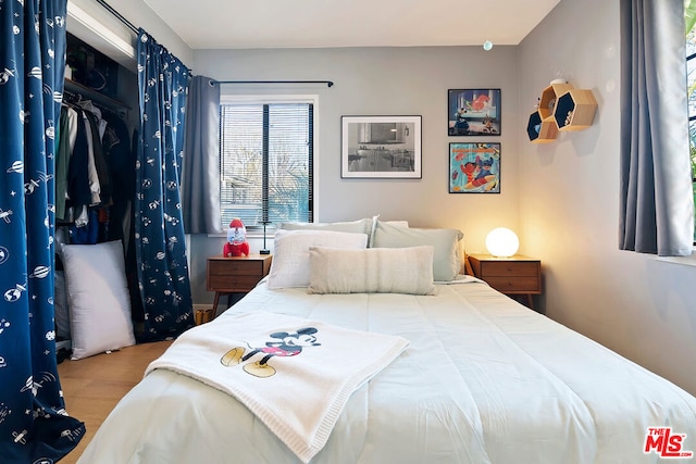 bedroom with wood-type flooring and a closet