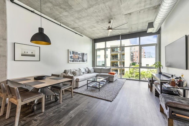 living room featuring dark wood-type flooring, expansive windows, and ceiling fan