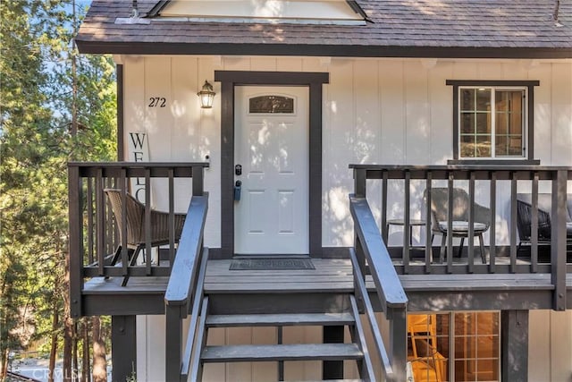 view of exterior entry with a wooden deck