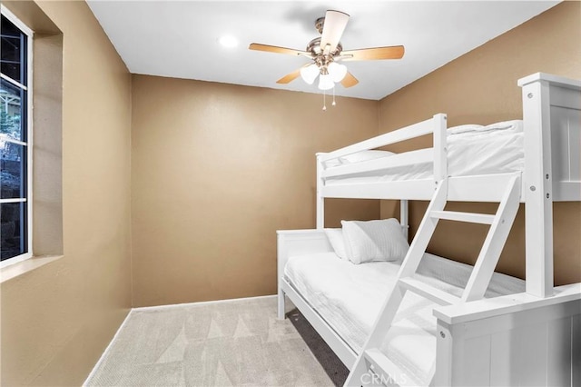 carpeted bedroom featuring ceiling fan