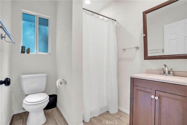 bathroom featuring toilet and vanity