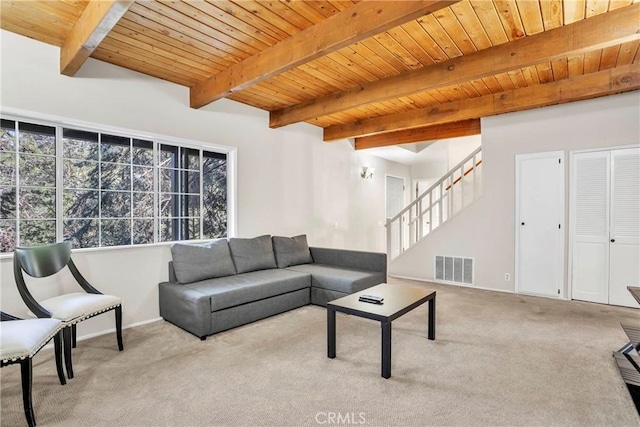 living room featuring beam ceiling, light colored carpet, and wood ceiling