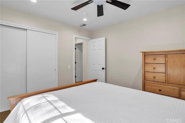 bedroom with ceiling fan and a closet