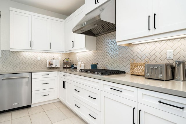 kitchen with white cabinetry, appliances with stainless steel finishes, and backsplash