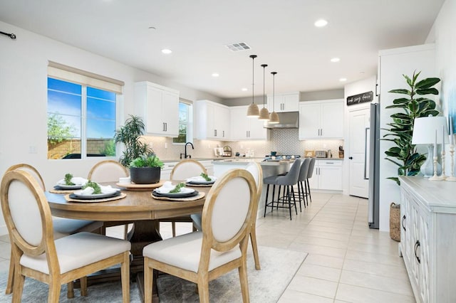 tiled dining space featuring sink