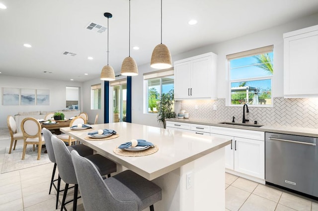 kitchen featuring sink, white cabinets, dishwasher, and a center island