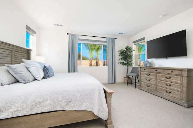 bedroom featuring light carpet