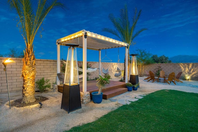 view of yard with a wooden deck and a fire pit