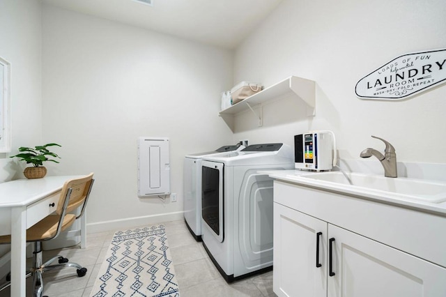 laundry area featuring cabinets, light tile patterned flooring, sink, and independent washer and dryer