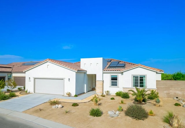 view of front facade featuring a garage and solar panels