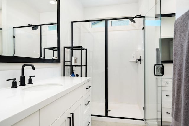 bathroom featuring vanity and an enclosed shower