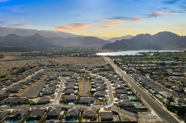 aerial view at dusk with a water and mountain view