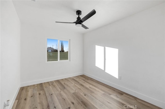 spare room featuring ceiling fan and light wood-type flooring