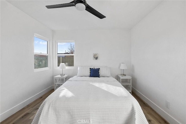 bedroom featuring ceiling fan and dark hardwood / wood-style floors