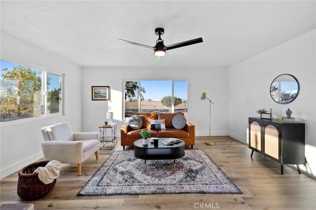 sitting room with ceiling fan and light hardwood / wood-style floors