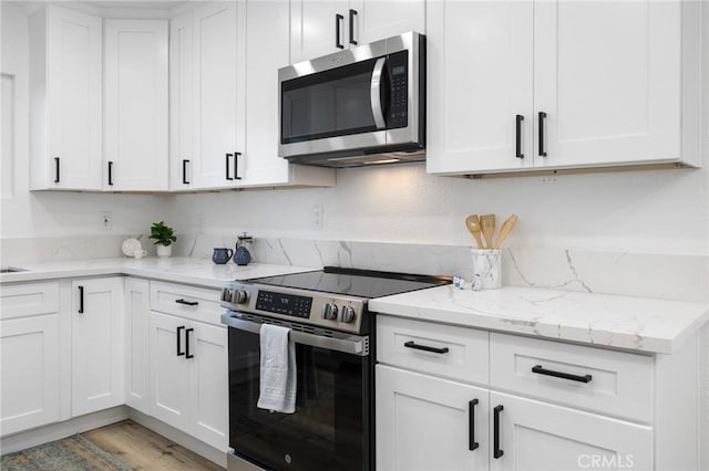 kitchen with stainless steel appliances and white cabinets