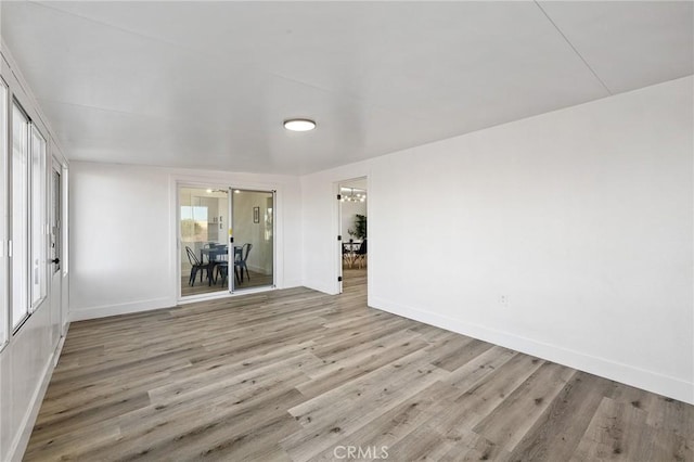 empty room featuring a wealth of natural light and light hardwood / wood-style flooring