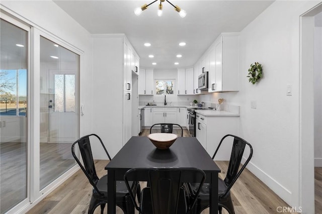 dining area featuring light hardwood / wood-style floors and sink