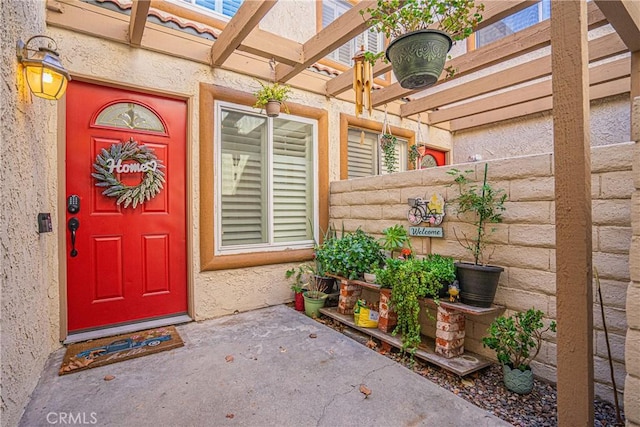 entrance to property with a pergola