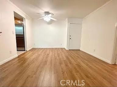 spare room with ceiling fan, hardwood / wood-style floors, and ornamental molding