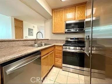 kitchen with sink, light tile patterned floors, and stainless steel appliances