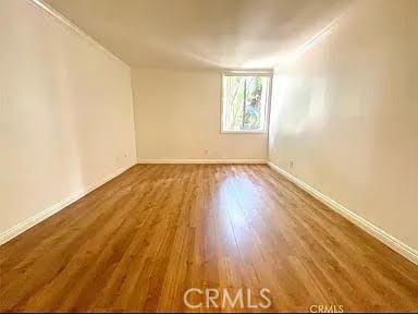 spare room with hardwood / wood-style flooring