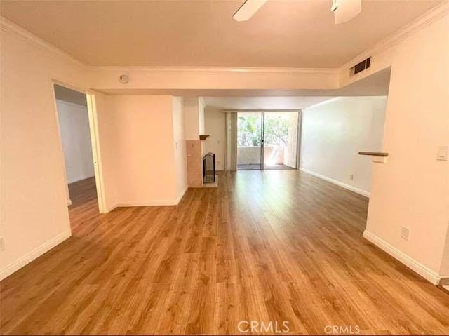 spare room with light hardwood / wood-style flooring and ornamental molding