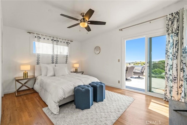 bedroom featuring access to outside, ceiling fan, and light wood-type flooring