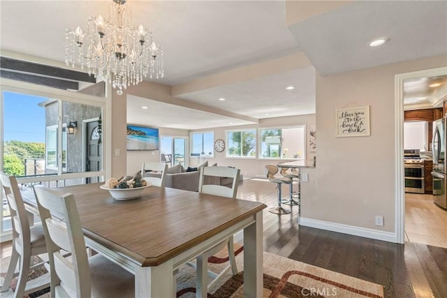 dining area with a notable chandelier and dark wood-type flooring