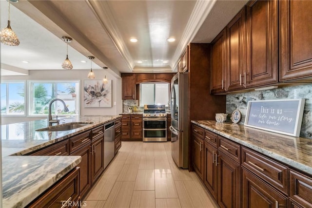 kitchen featuring stainless steel appliances, sink, pendant lighting, and decorative backsplash