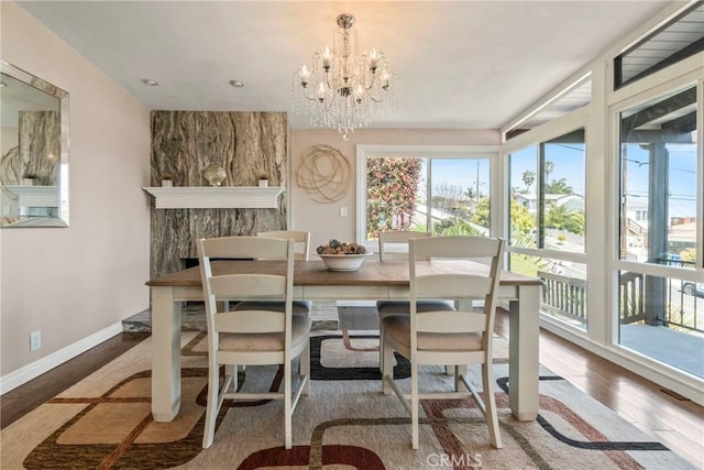 dining area featuring an inviting chandelier and wood-type flooring