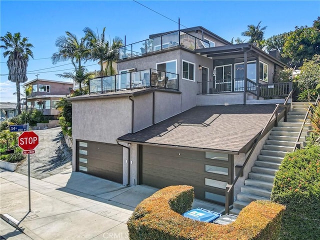 contemporary home featuring a garage and a balcony