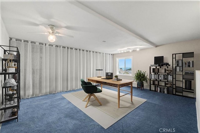 carpeted home office featuring beam ceiling and ceiling fan